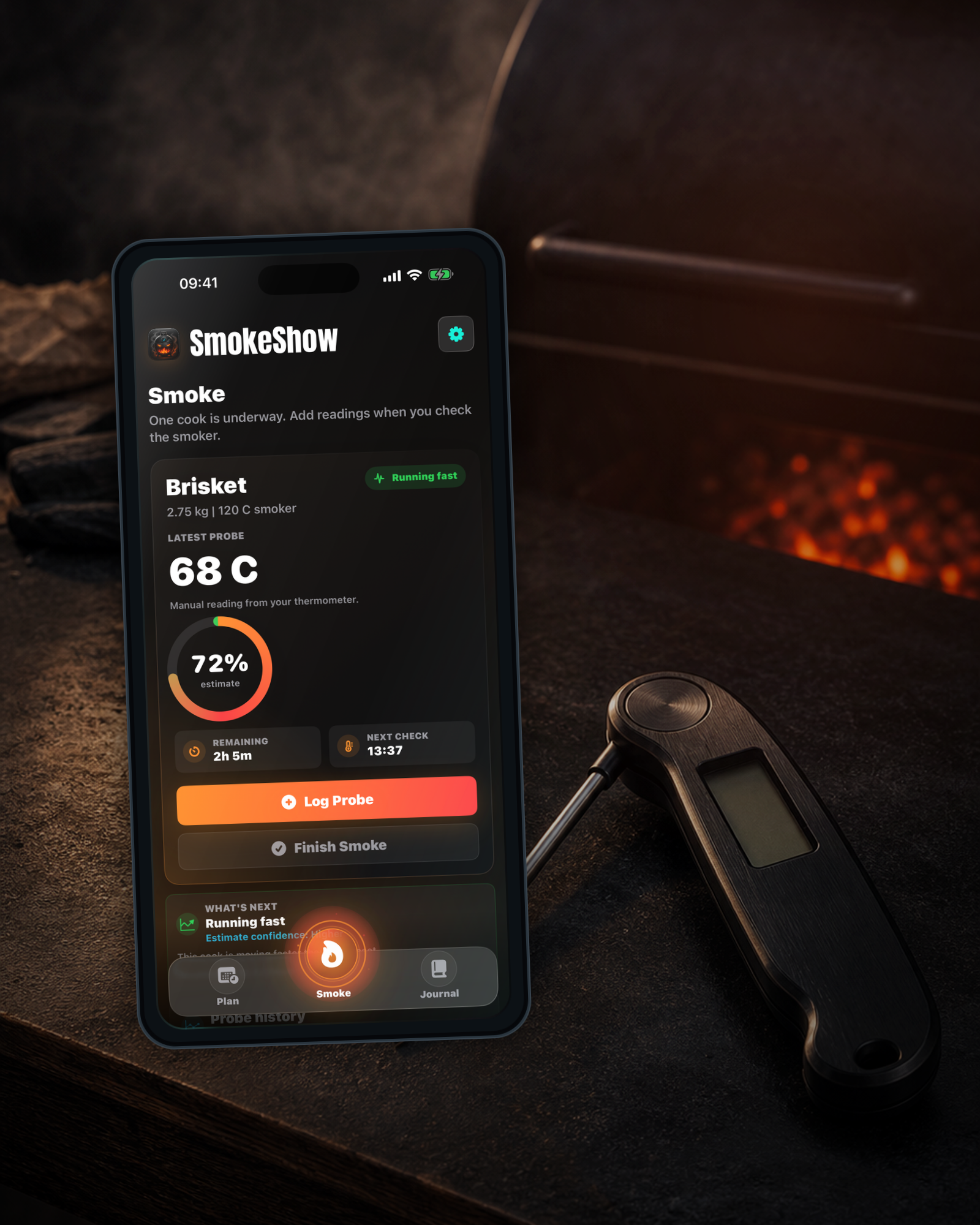 SmokeShow active Smoke screen beside a manual digital instant-read thermometer and grill glow